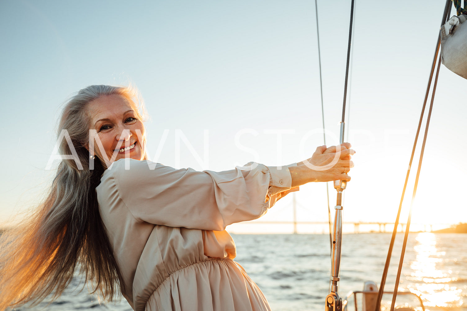 Beautiful senior woman standing on a yacht and looking at camera	