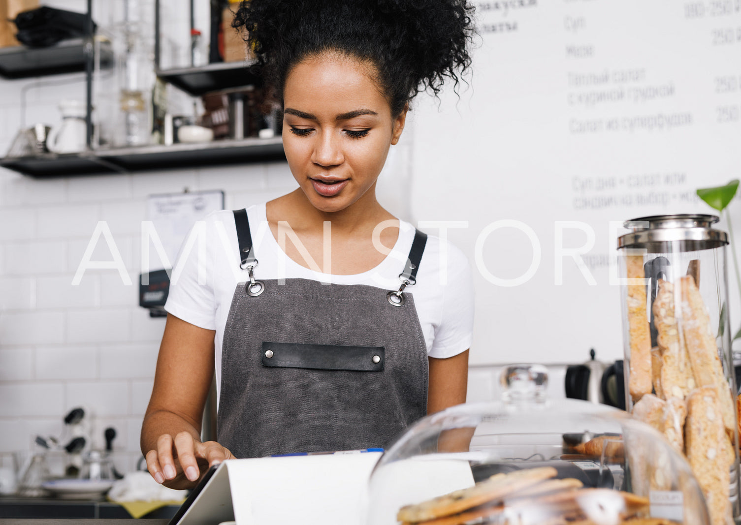 Waitress using a digital tablet at a table in coffee shop	