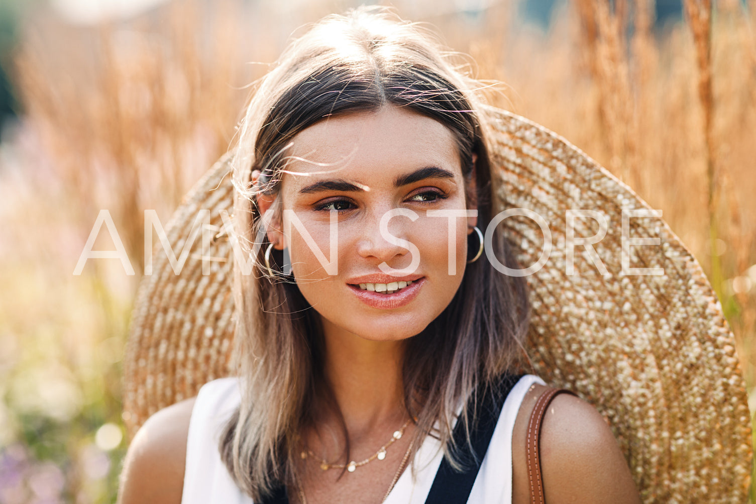 Portrait of a beautiful caucasian woman with straw hat	