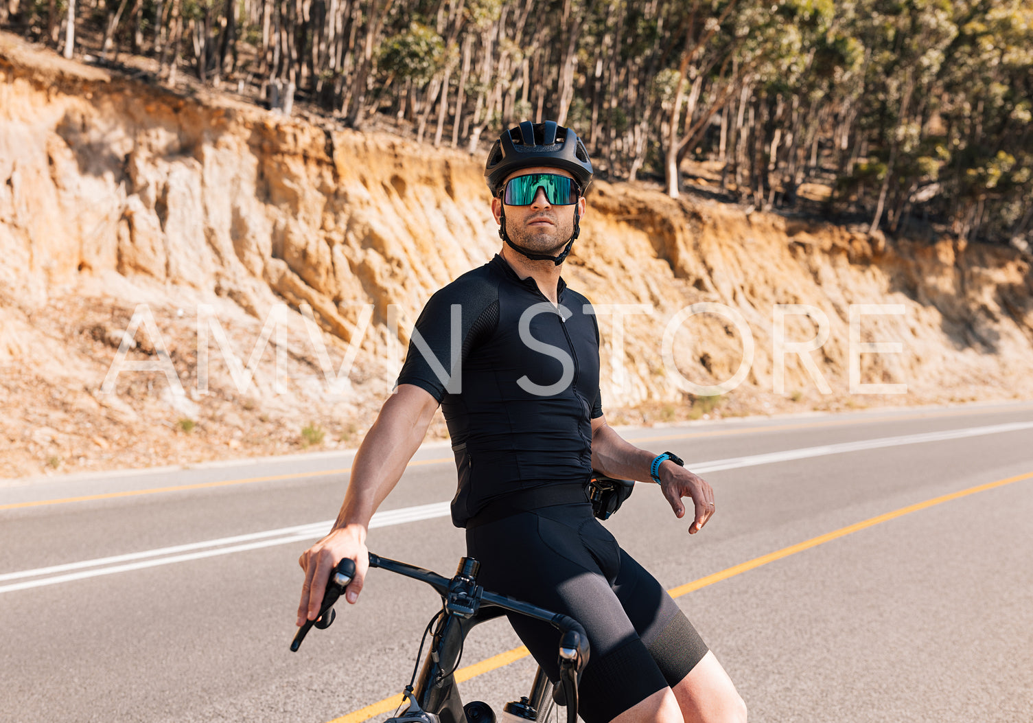 Young male professional cyclist relaxing after ride