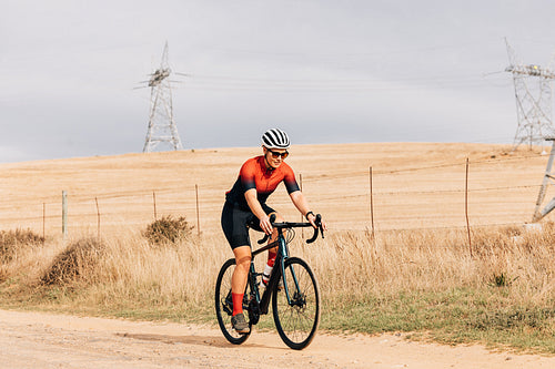 Professional athlete cycling on countryside. Cyclist riding bike.