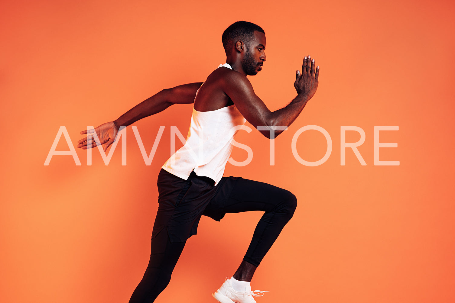 Cropped shot of a male runner sprinting in studio over orange background