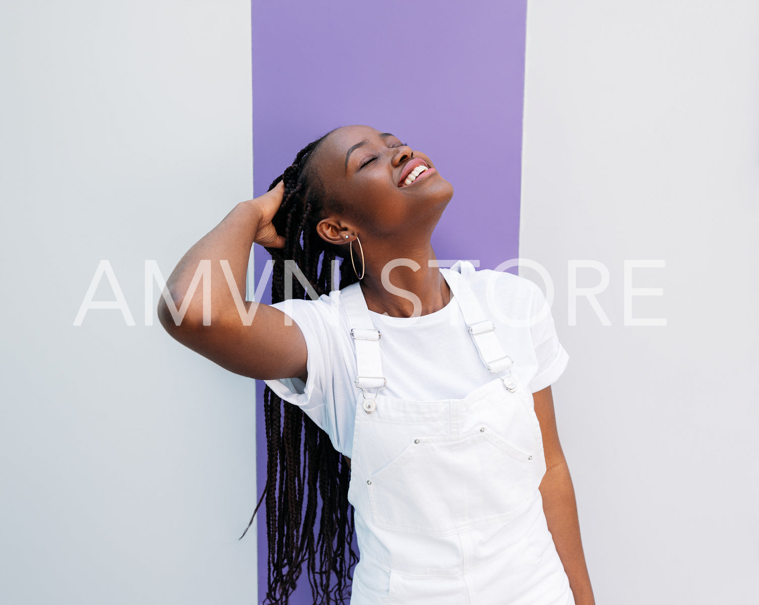 Positive young woman with braids standing with closed eyes wearing casual clothes