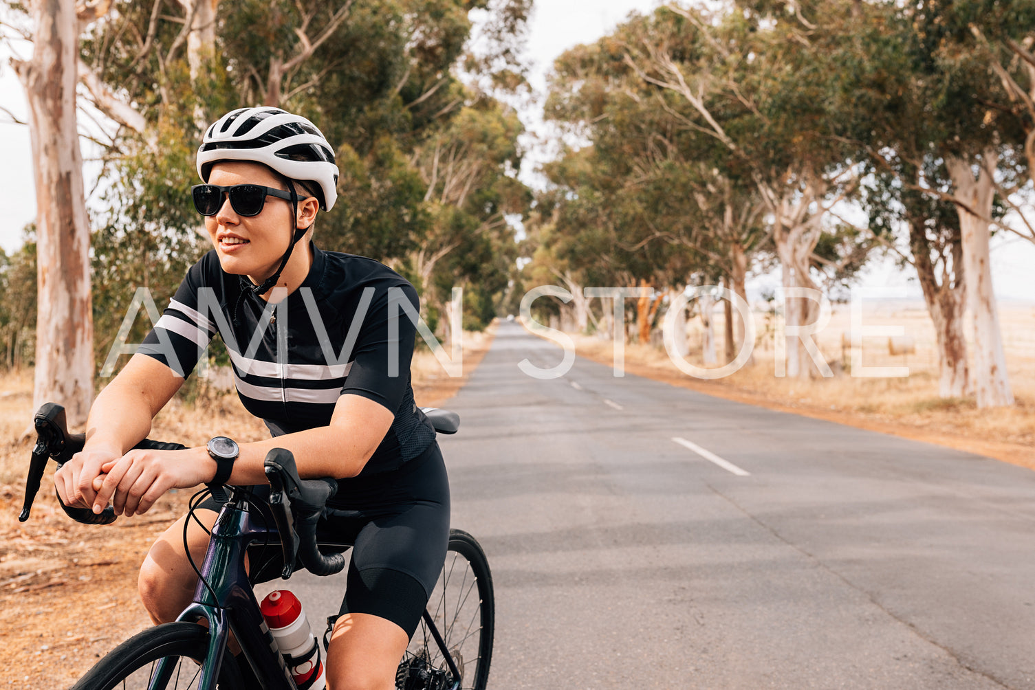 Woman cyclist sitting on her bike resting during outdoors ride