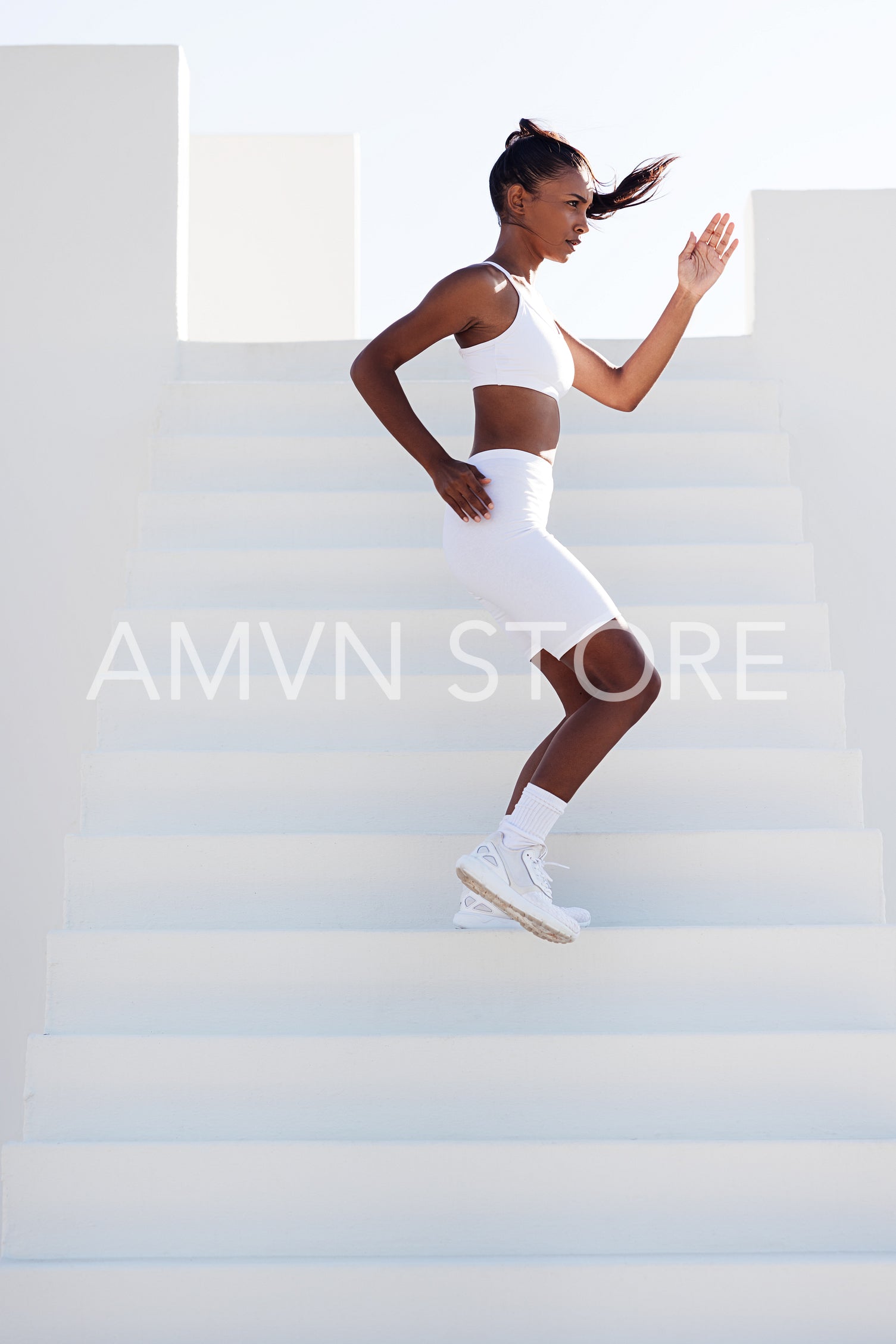 Full length of a slim female stepping down stairs outdoors. Young slim sports woman jogging on stairs.