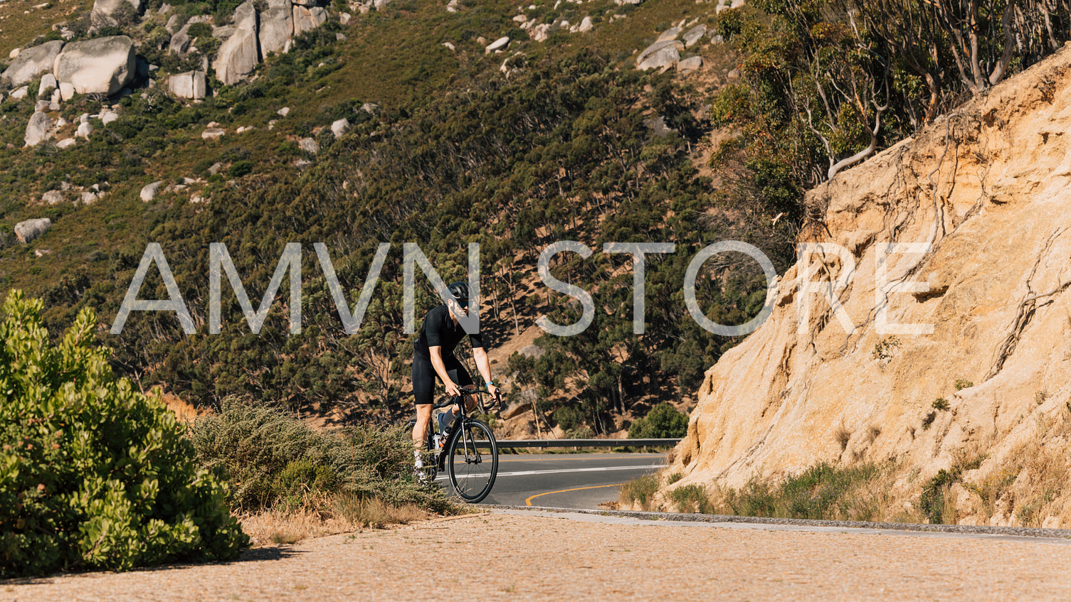 Professional male cyclist on a road bike in wild terrain