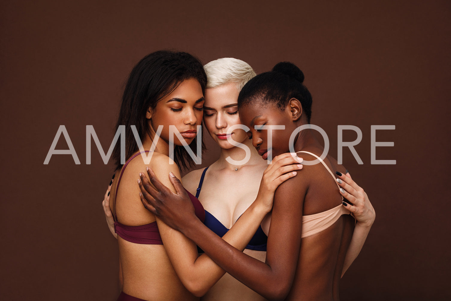 Group of beautiful young women hugging together in their underwear	