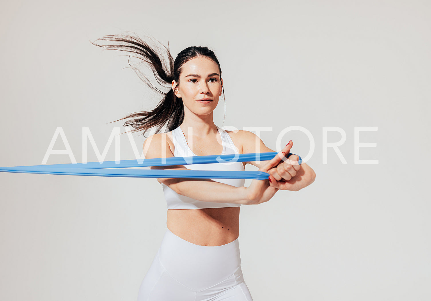 Young and confident female athlete warming up her hands over white background