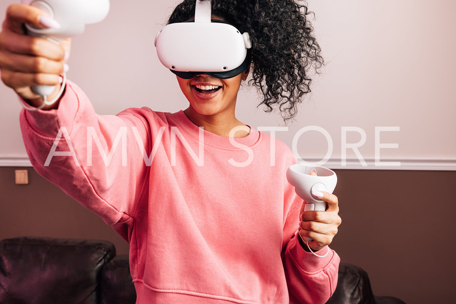 Young African American female in VR goggles and with joysticks e