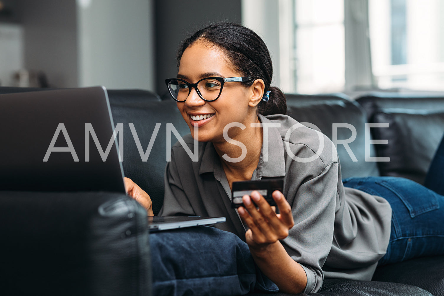 Beautiful woman making an online payment with credit card using laptop	