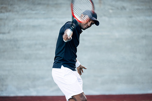 Professional tennis player hitting the serve during a match