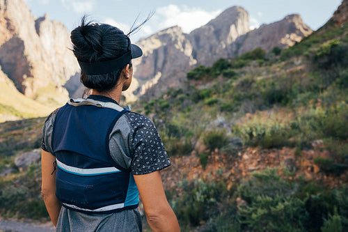 Woman in hiking attire looking at the mountains