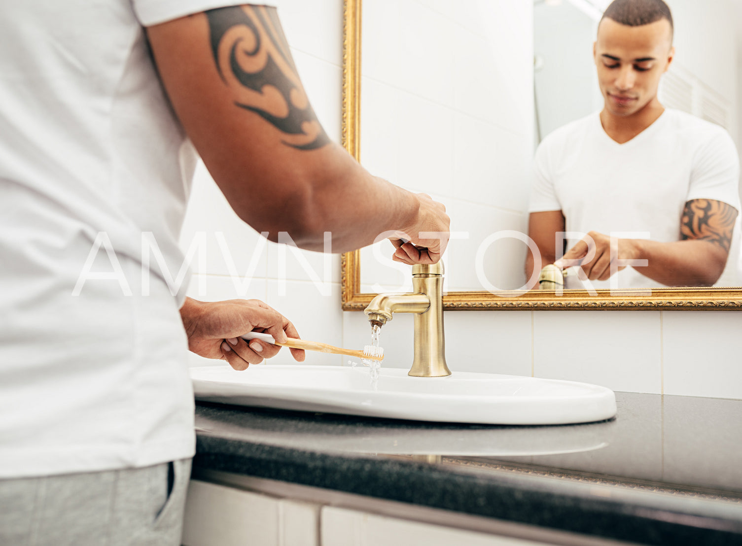 Young handsome man cleaning his bamboo toothbrush with water	