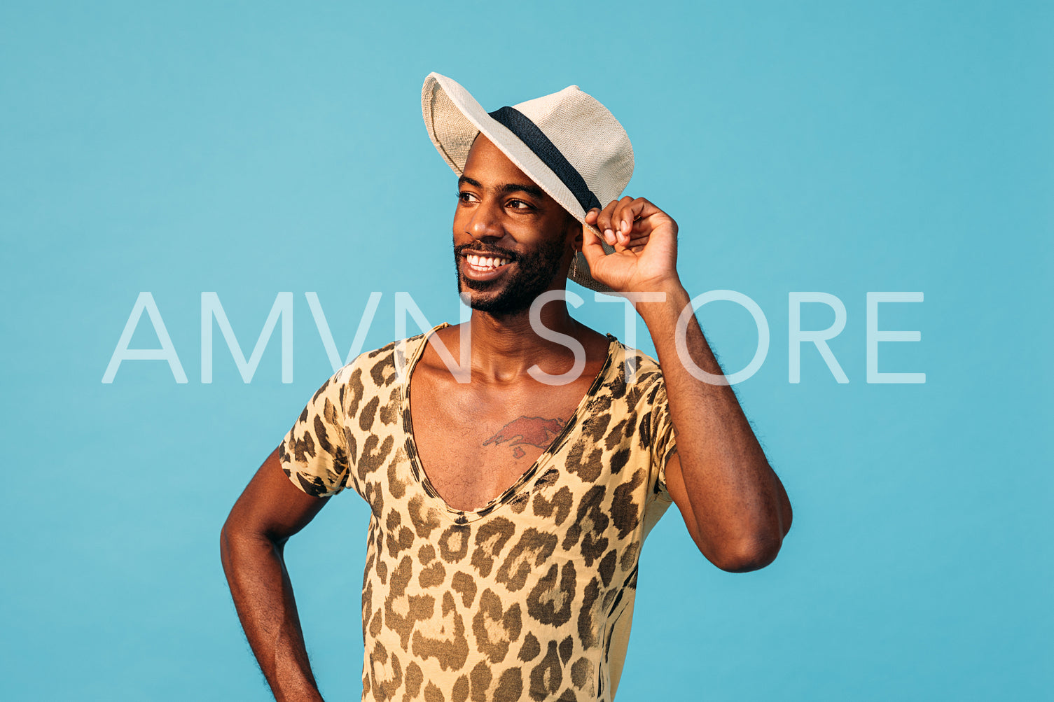 Portrait of a stylish African American guy against blue background