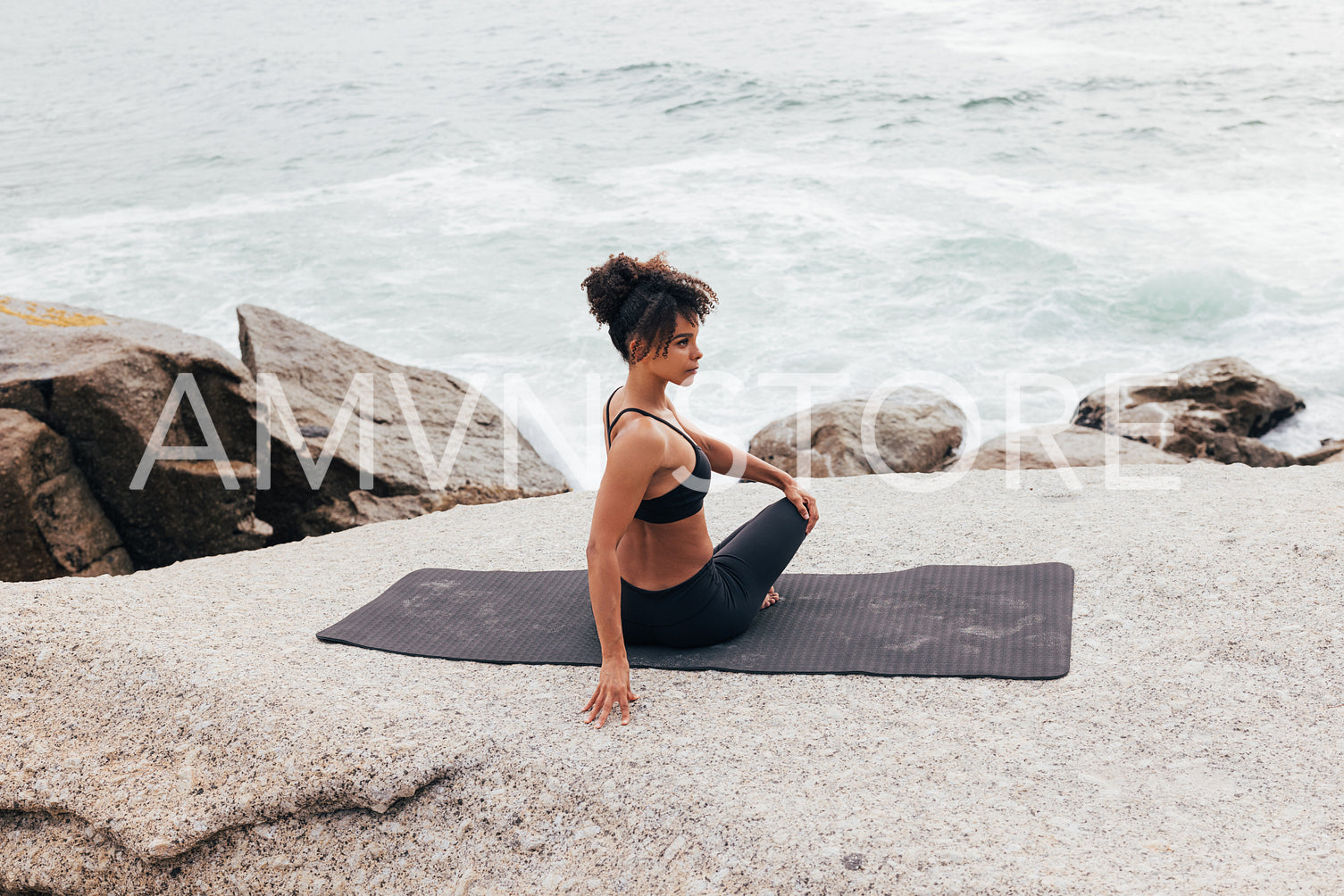 Woman doing side turn on mat warming up her body before yoga training