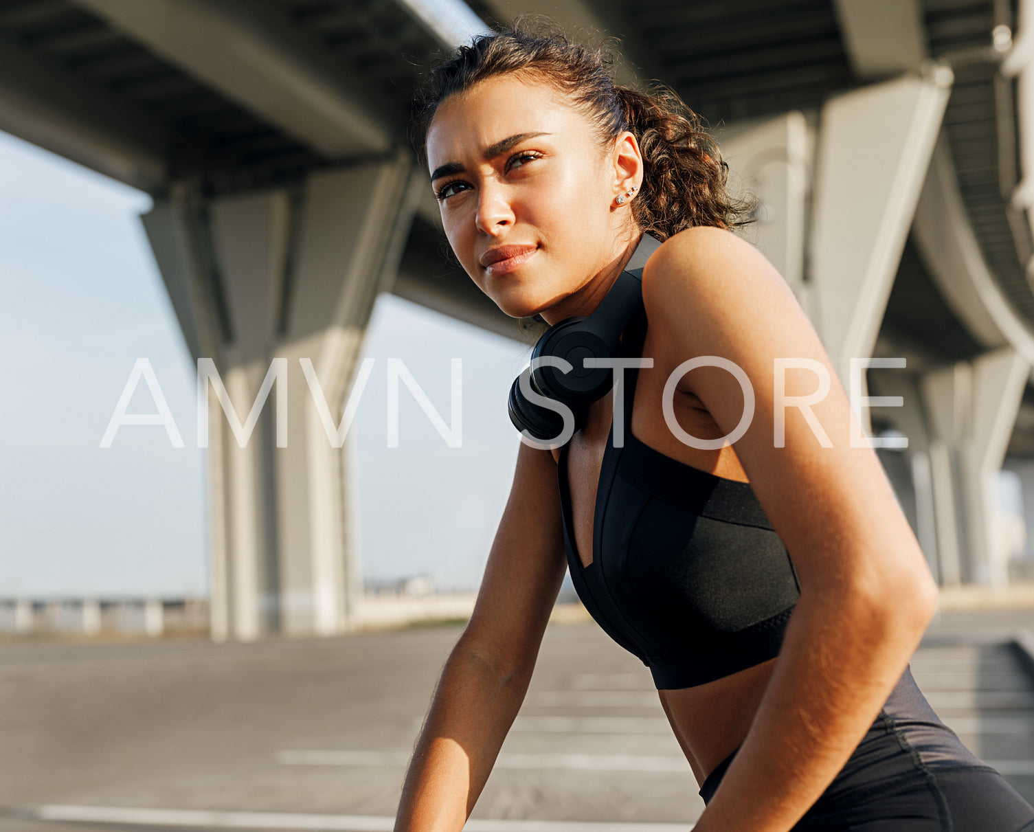 Female athlete taking rest after fitness training looking away	