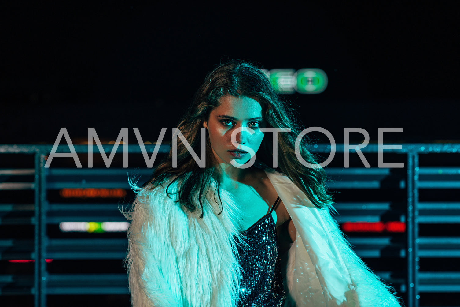 Beautiful young woman looking at camera wearing white fur coat	