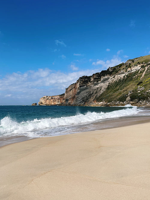 Beach and an ocan with waves at sunny day