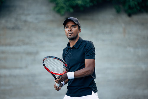 Tennis player looking after his serve