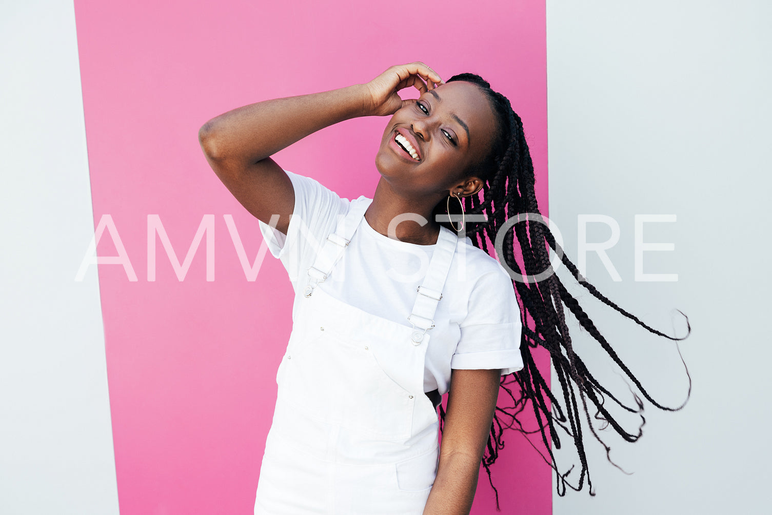 Portrait of a young positive woman in white casual clothes looking at the camera