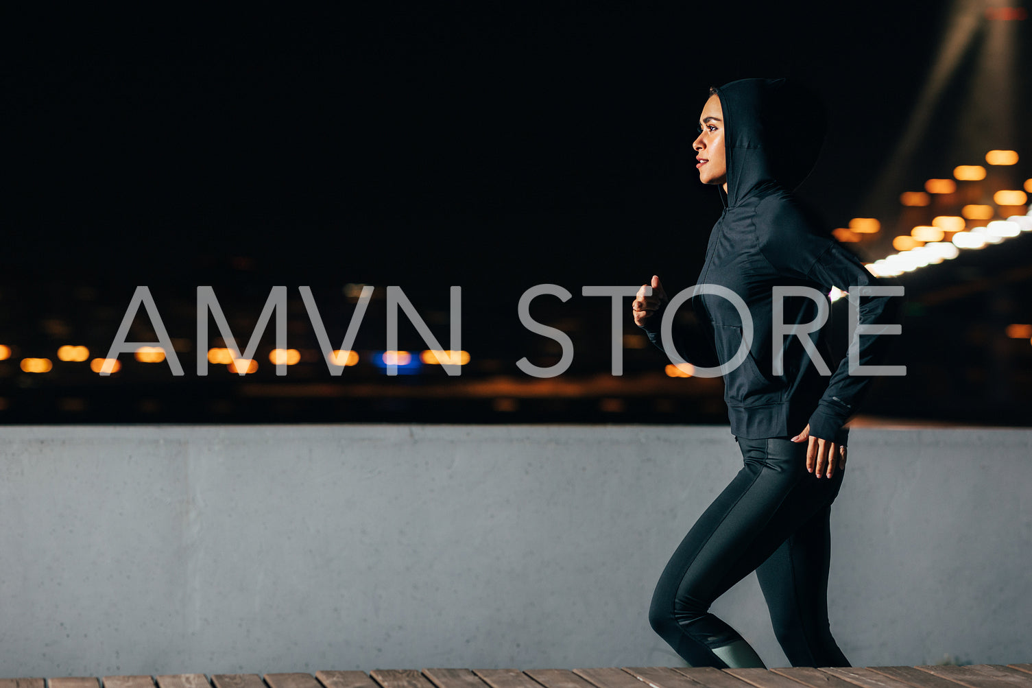 Side view of young female jogger exercising outdoors at night. Woman running along the embankment.