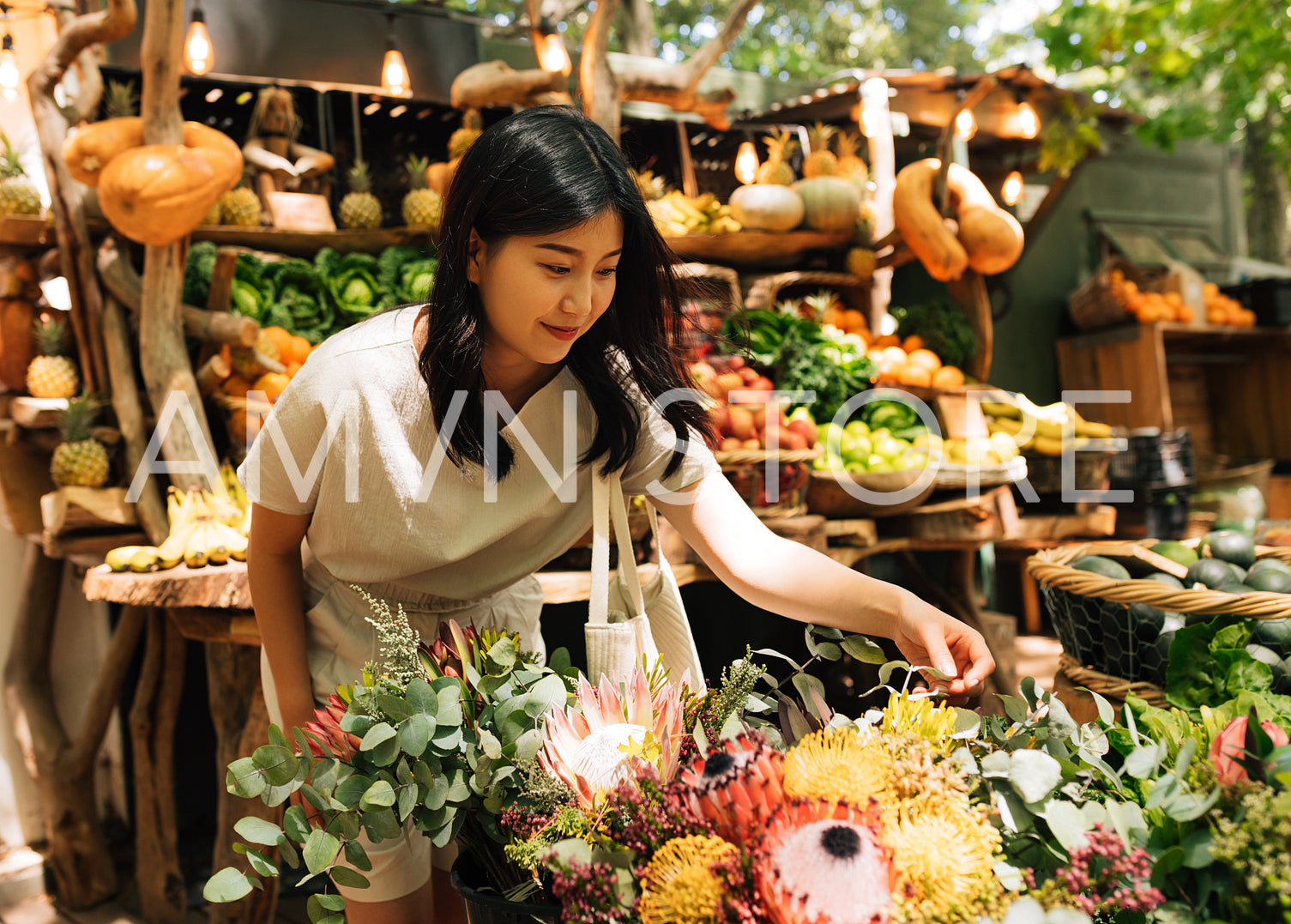 Asian woman in casual choosing flowers