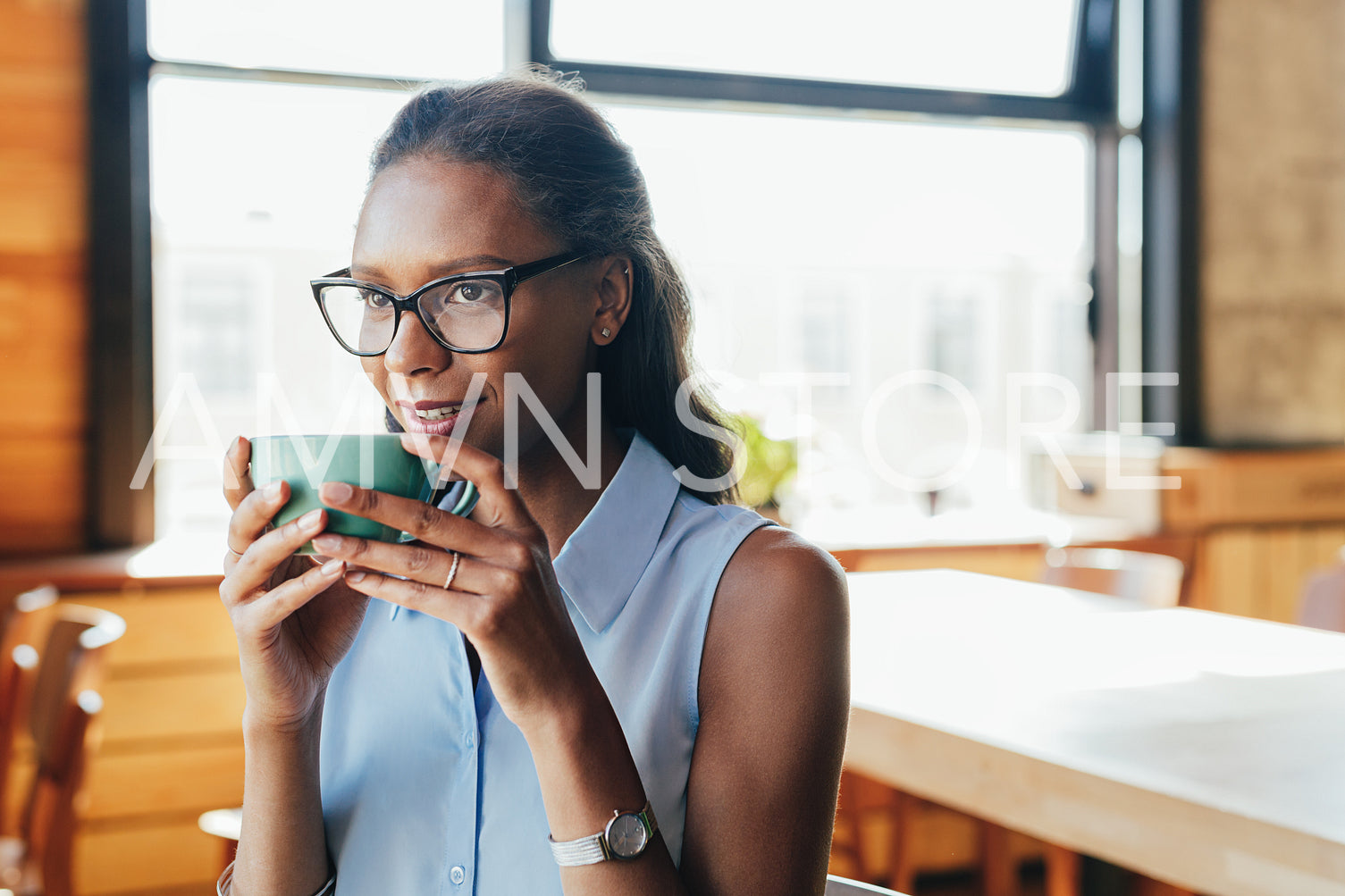 Beautiful woman sitting at cafe drinking coffee	