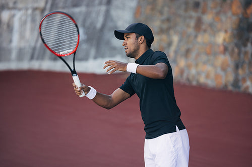 Tennis player in sportswear on an outdoors hard court