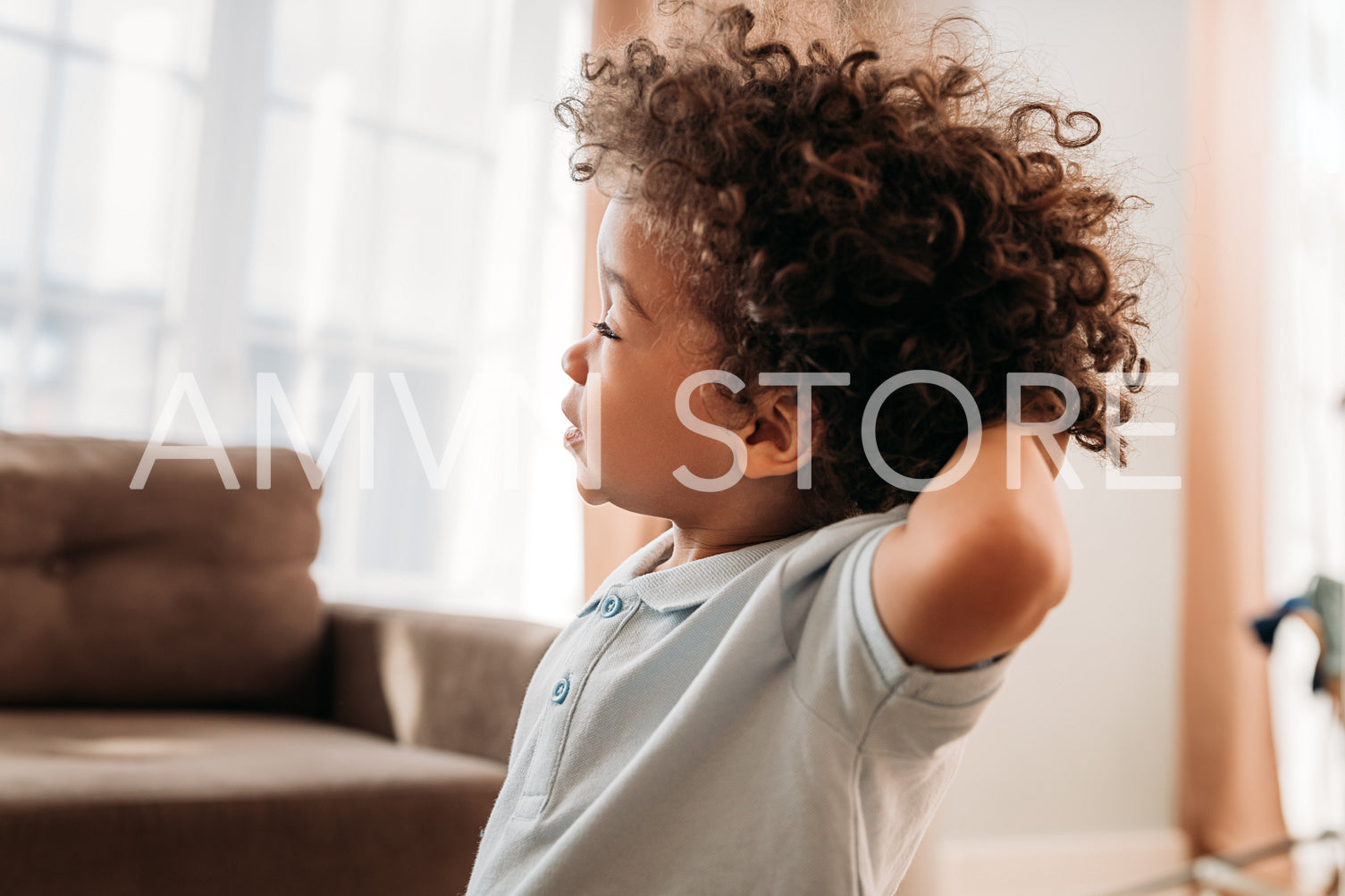 Close up of a cute little boy standing at home