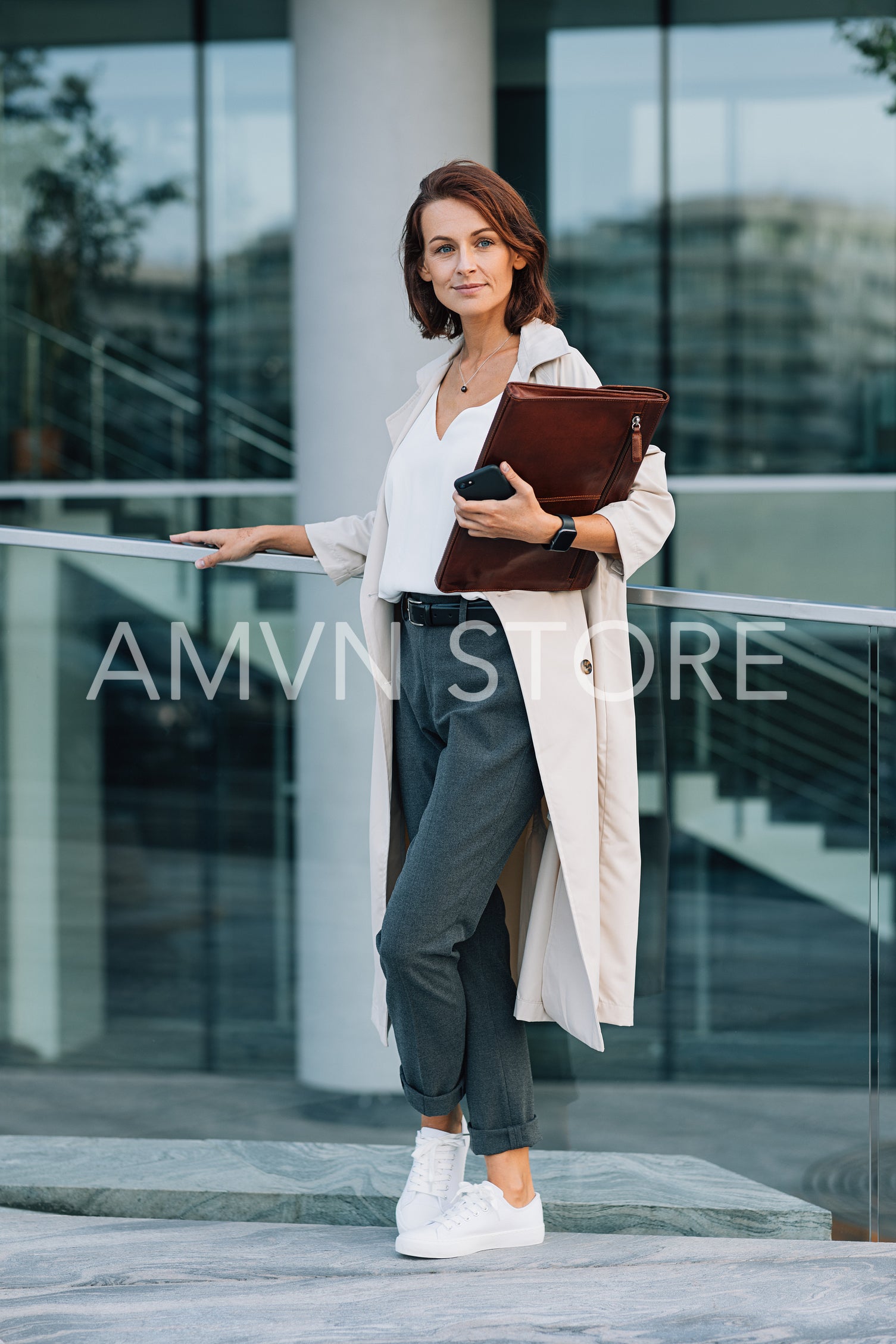 Full length of a stylish middle aged business woman standing outdoors