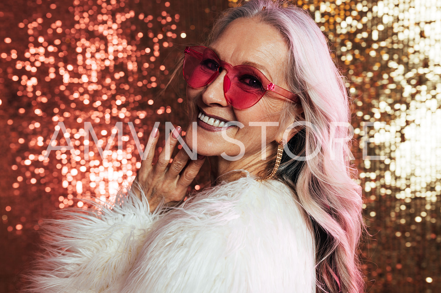 Portrait of a smiling senior woman with grey hair wearing pink e