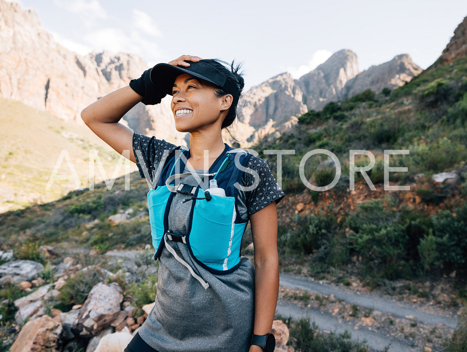 Happy middle-aged woman hiker enjoying the view