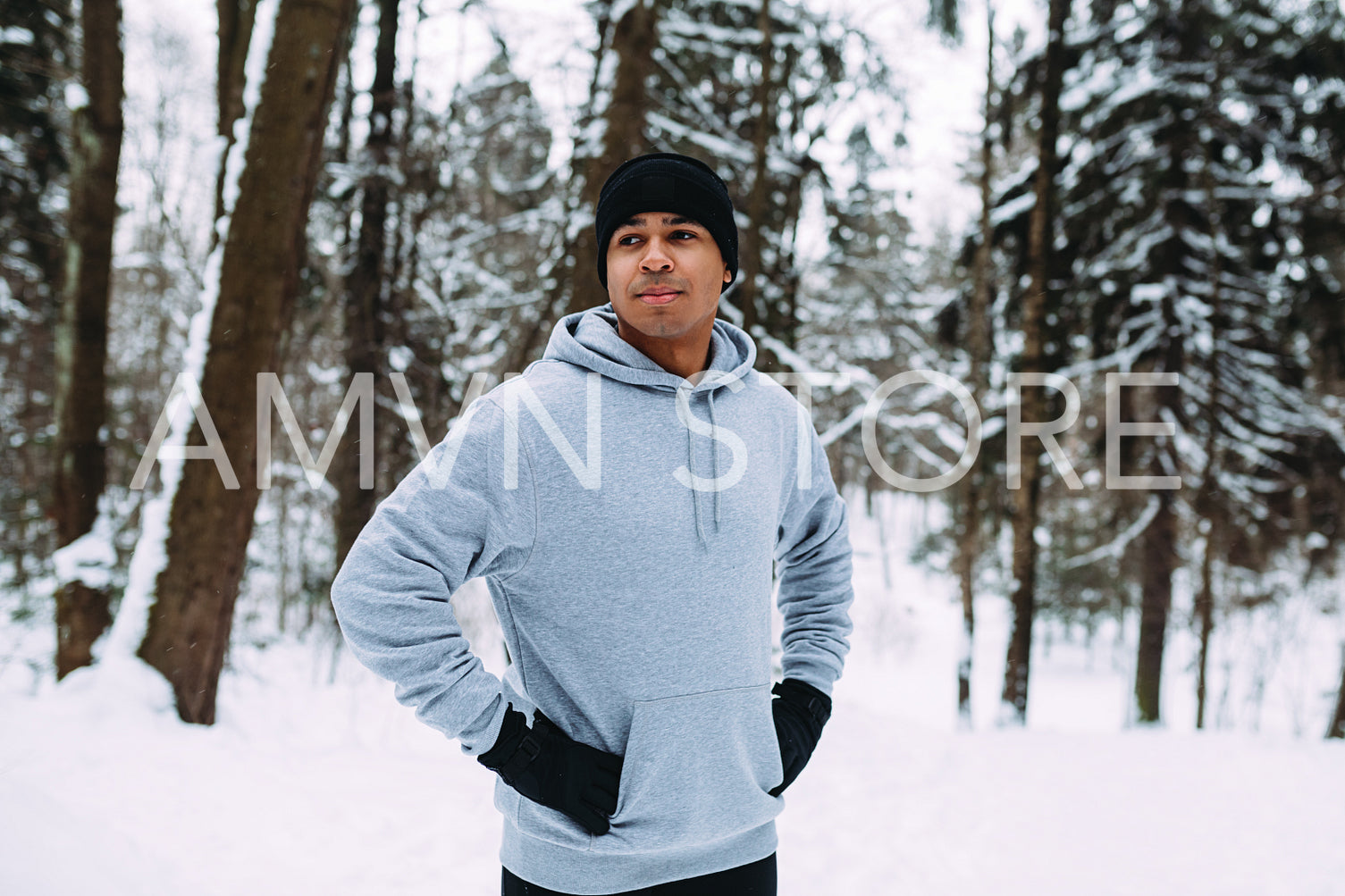 Athlete standing in a forest. Man resting after exercises.	
