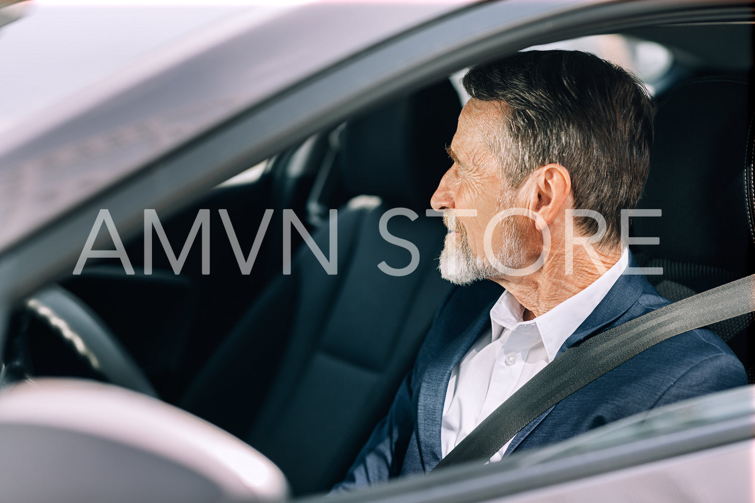 Side view of a bearded driver looking away	