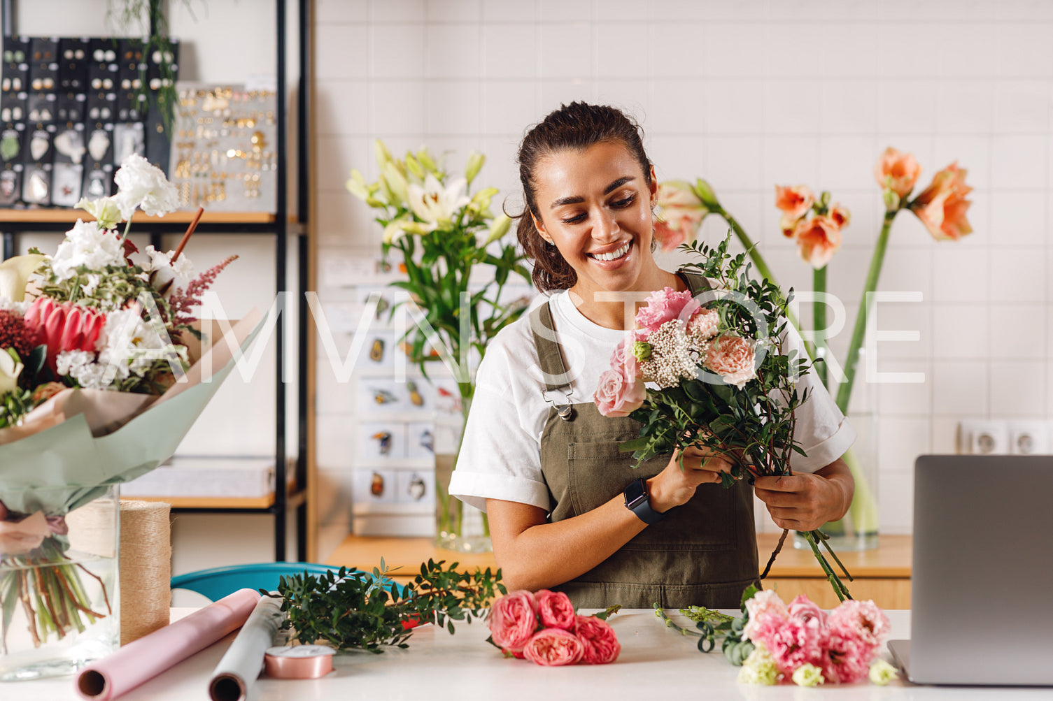 Smiling florist woman holding a bouquet 