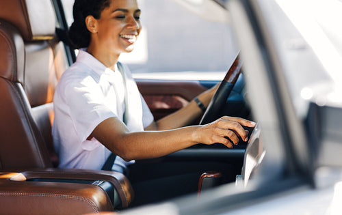 Woman driver touching the dashboard in a car