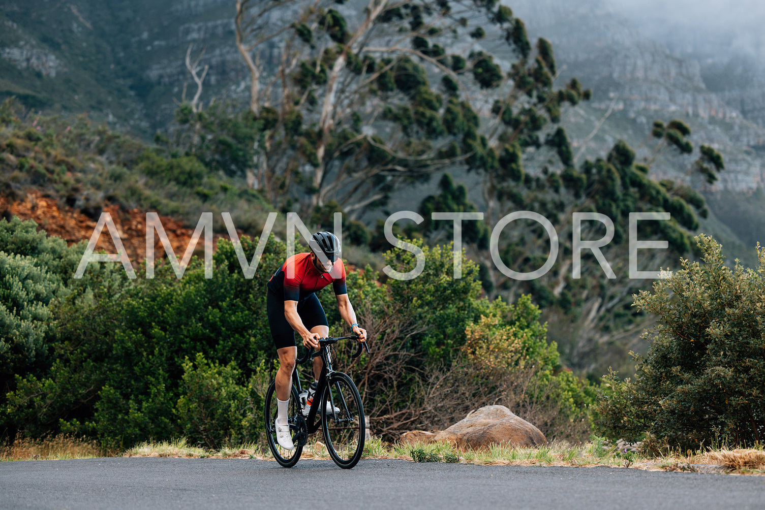 Young male doing intense training on bicycle in wild terrain. Man doing a training on bicycle.