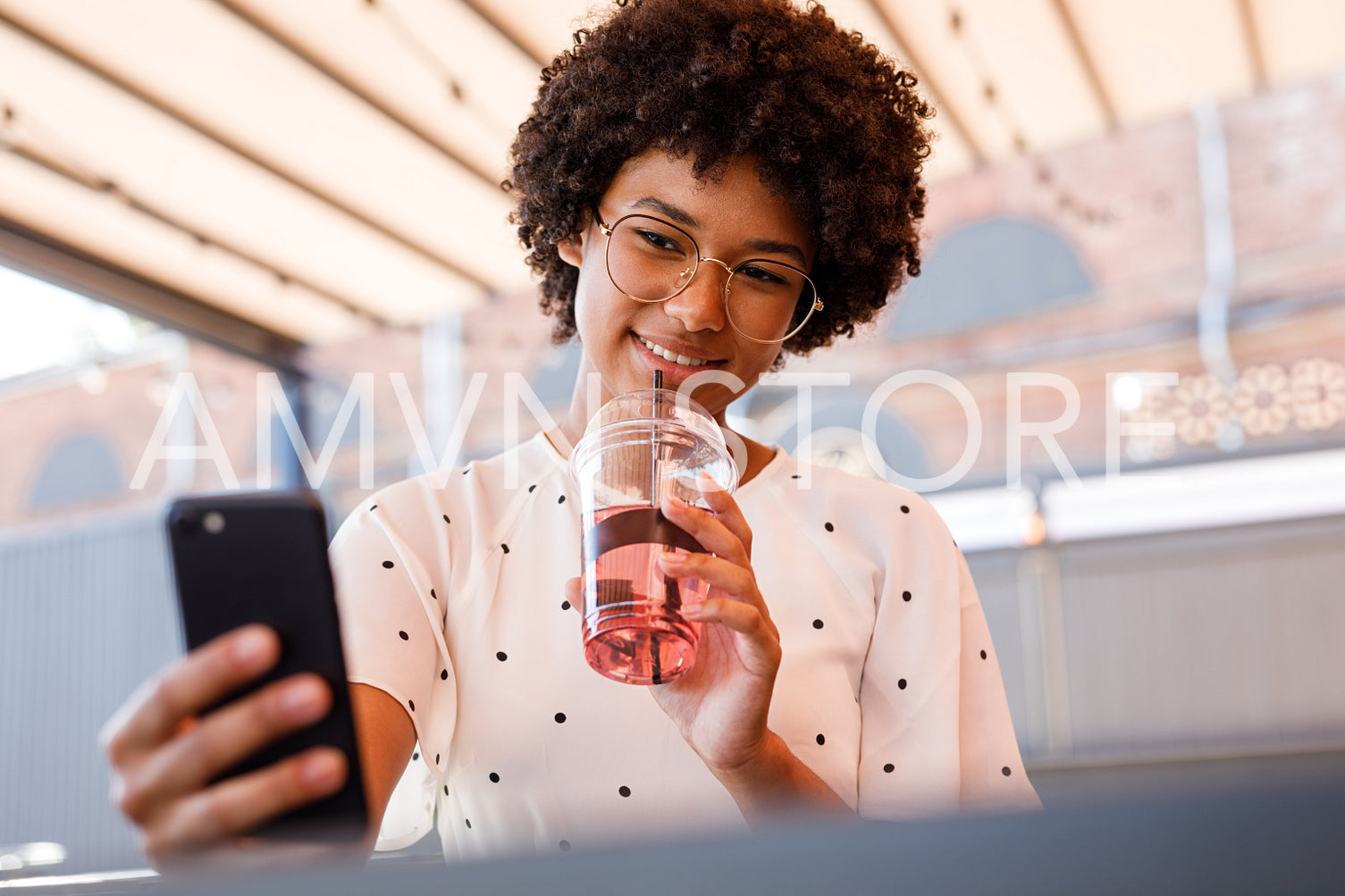 Woman drinking juice and photography on smartphone	