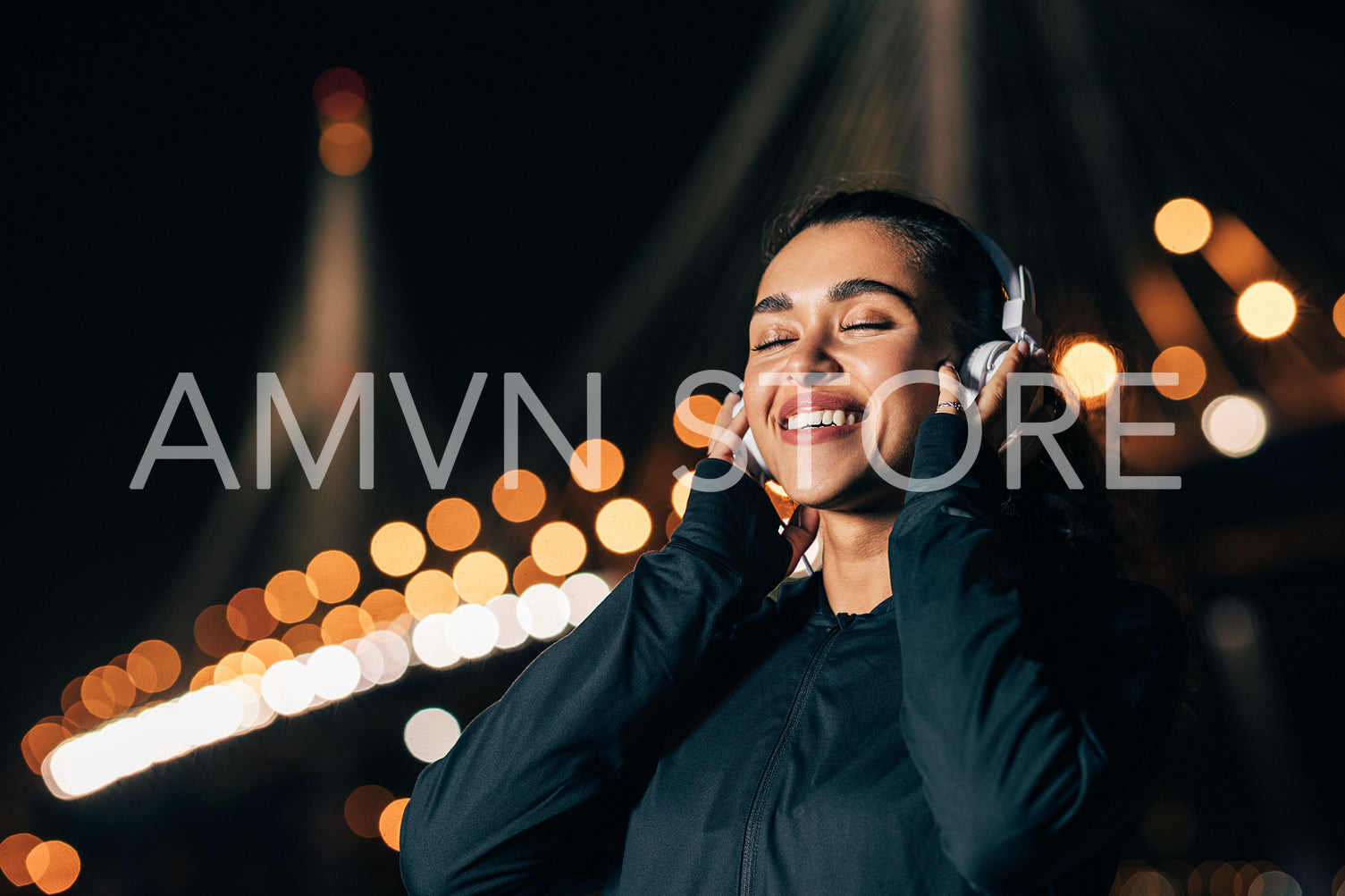 Happy woman wearing white wireless headphones listening to music with closed eyes