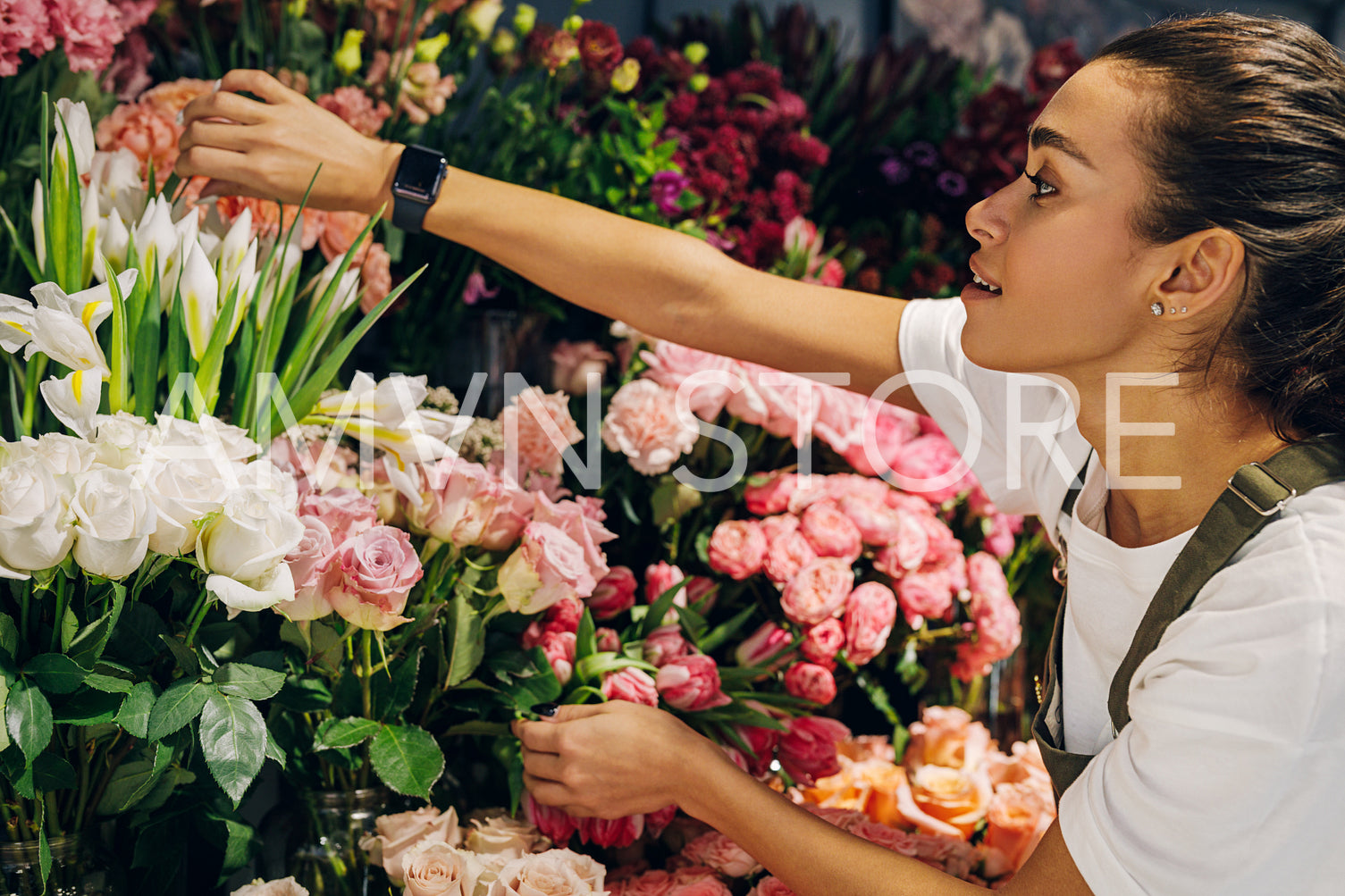 Florist woman choosing a flower in her shop	