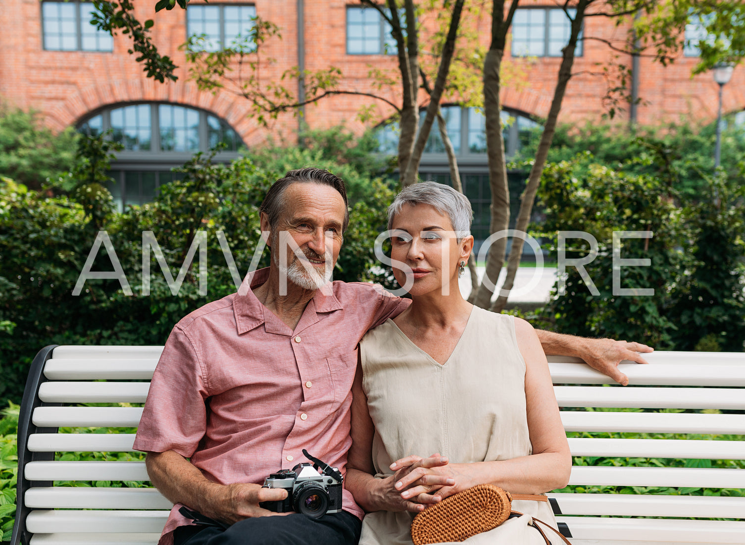 Aged couple sitting on a bench in the park