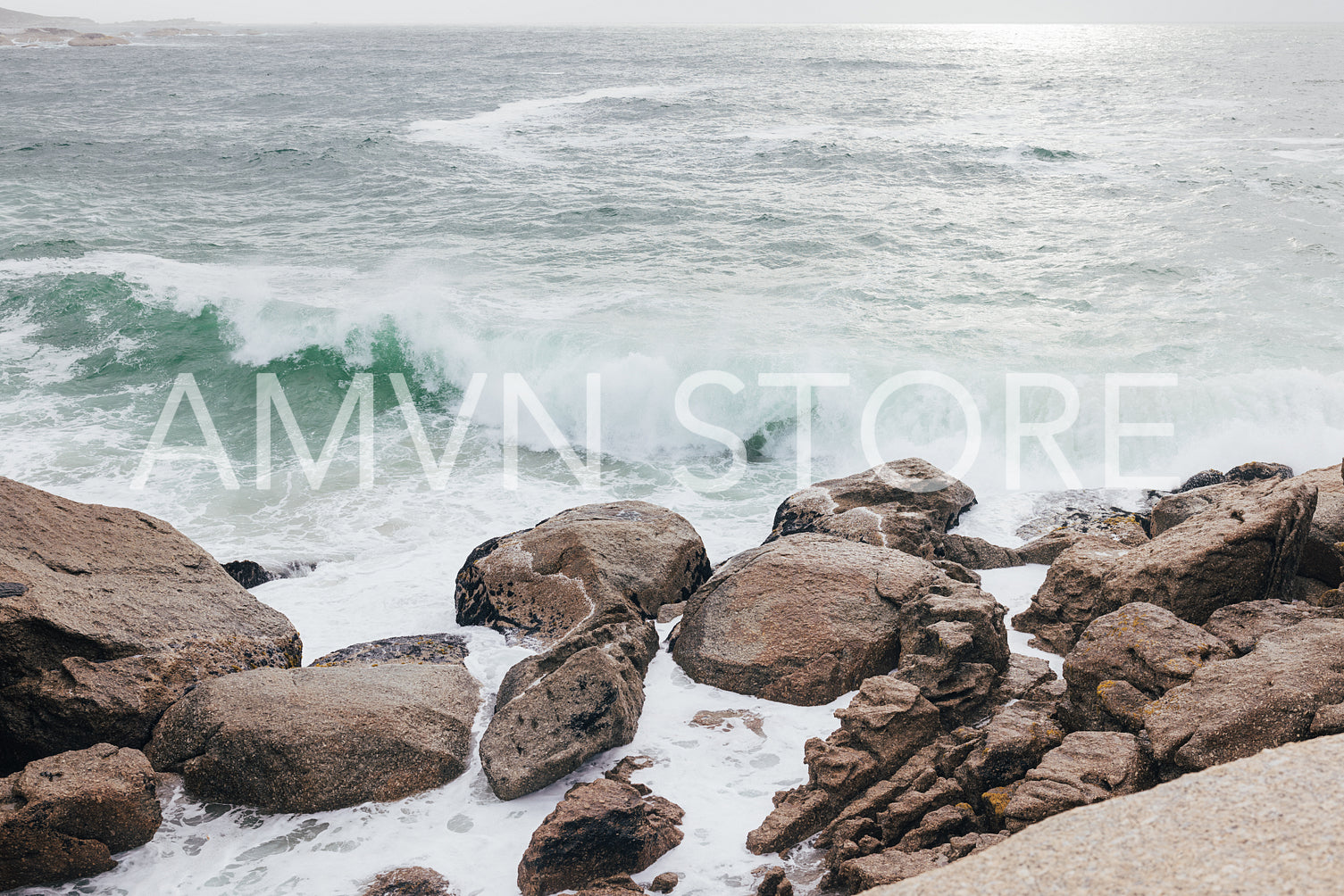 Oceanside with a lot of stones and waves