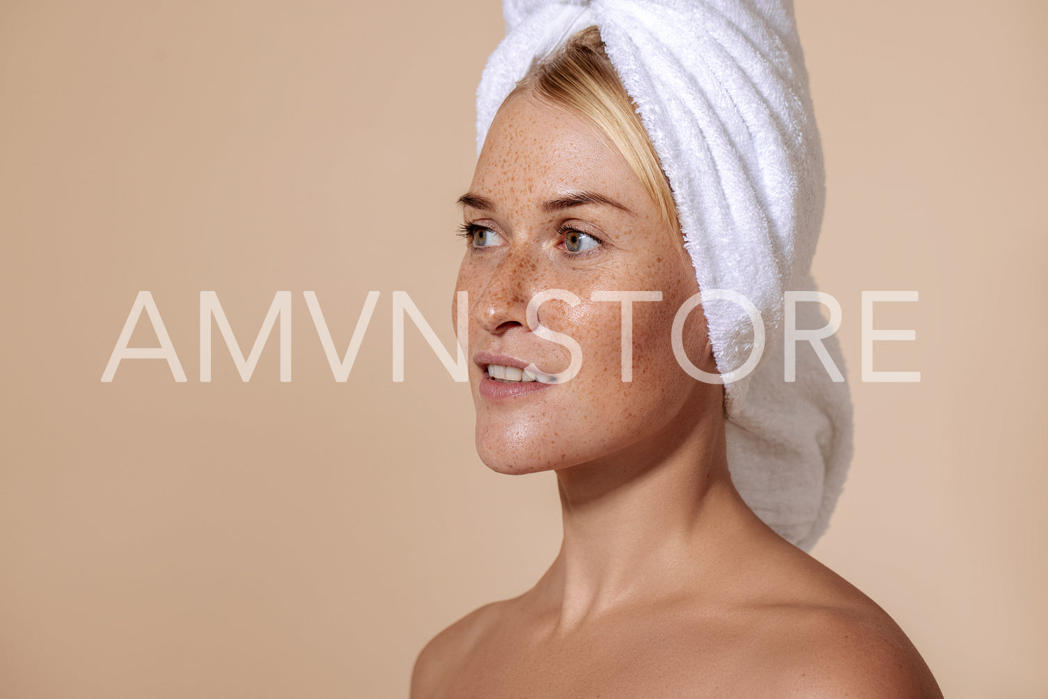 Portrait of young confident woman with freckles. Studio shot of