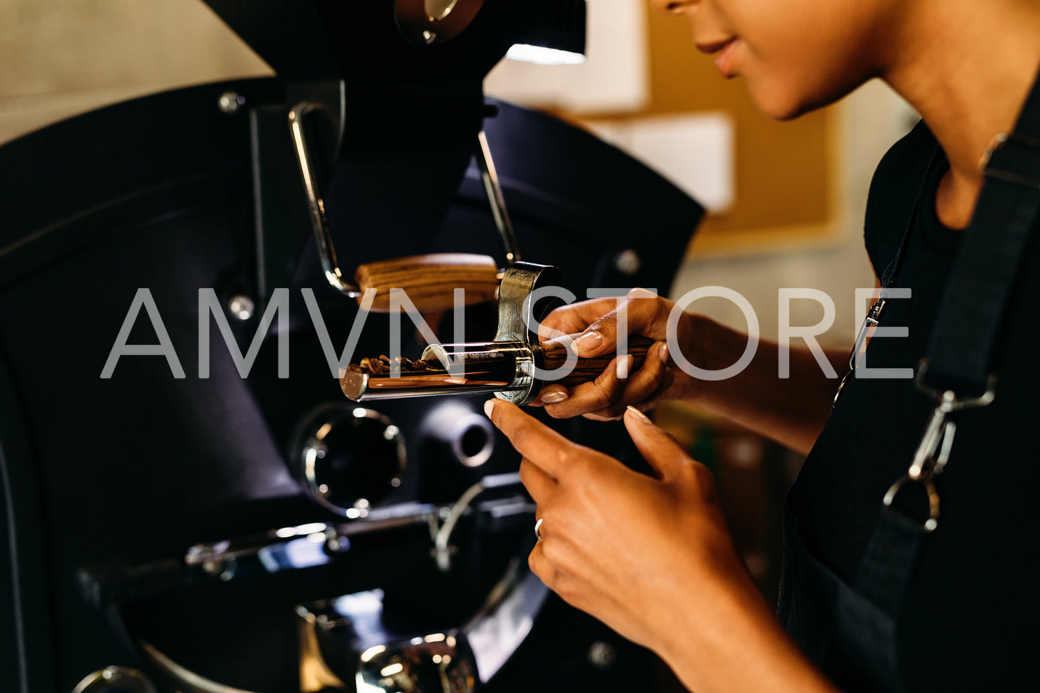 Unrecognizable woman checking a quality of roasted coffee beans	