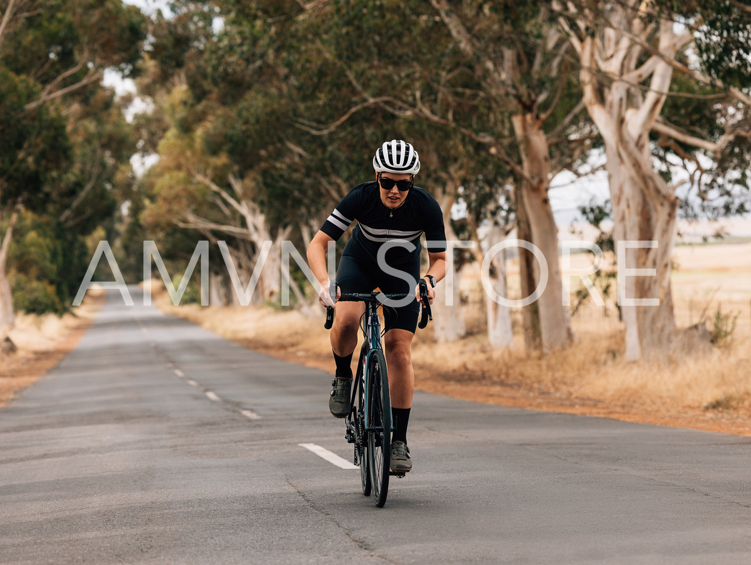 Professional female cyclist doing intense training on empty countryside road