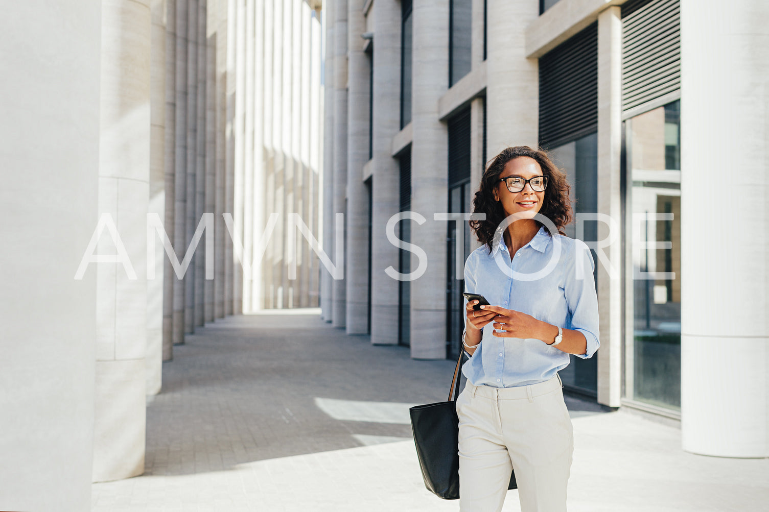 Businesswoman wearing formal clothes standing in front of a modern office building	