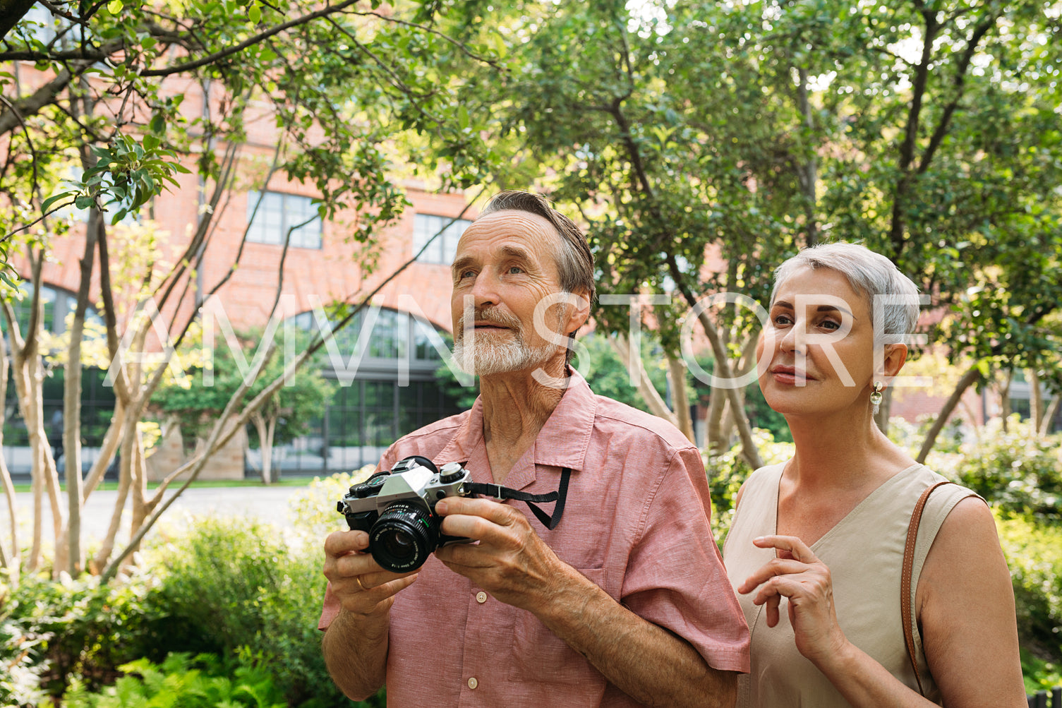 Two senior tourists exploring the park during vacation