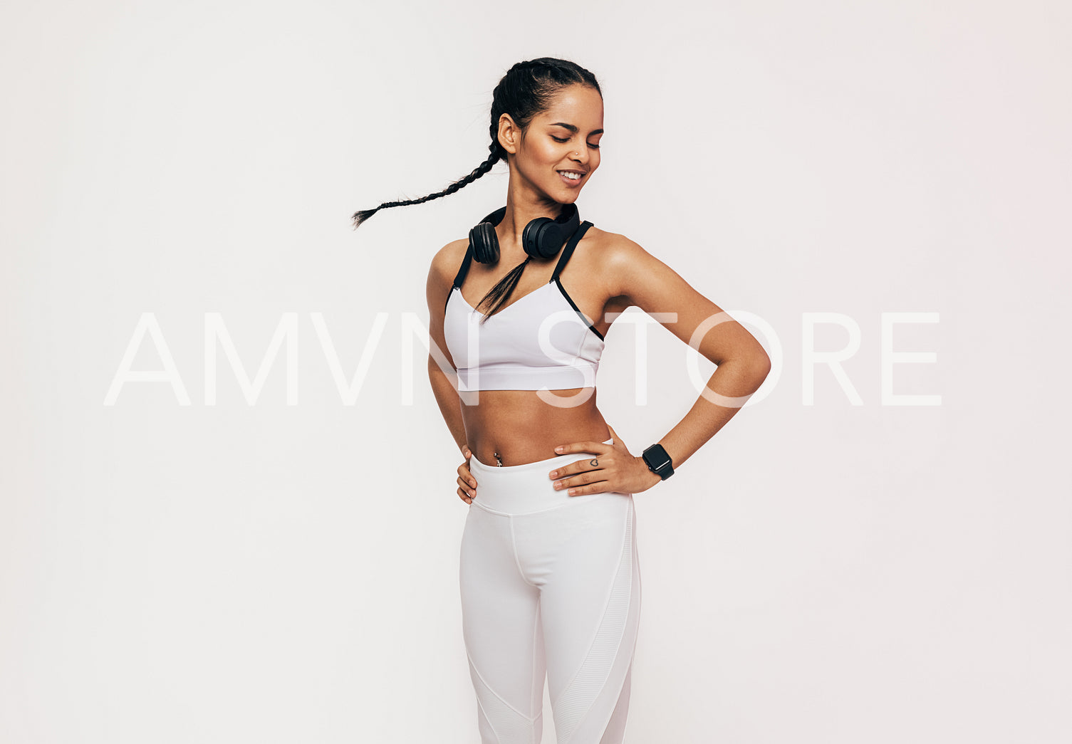 Smiling sportswoman with closed eyes having fun in studio