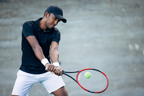 Tennis player takes serve. Professional tennis player hitting a ball.