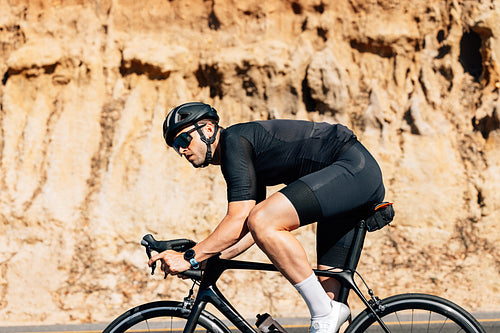 Bicycle rider in helmet and goggles exercising outdoors